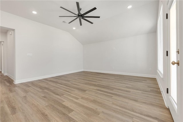 additional living space featuring light wood finished floors, baseboards, lofted ceiling, recessed lighting, and a ceiling fan