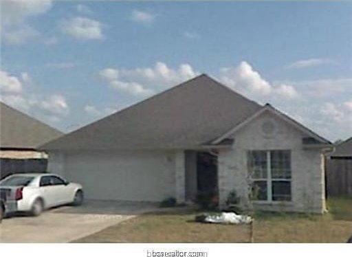 single story home featuring an attached garage and concrete driveway