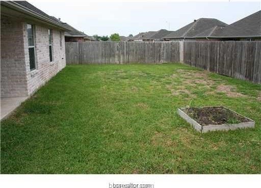 view of yard featuring a garden and a fenced backyard