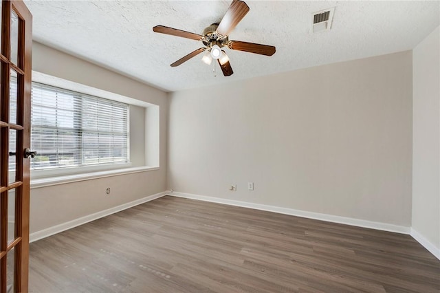 empty room with wood-type flooring, a textured ceiling, and ceiling fan