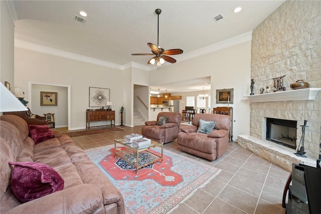 living area with visible vents, ornamental molding, tile patterned flooring, and stairway