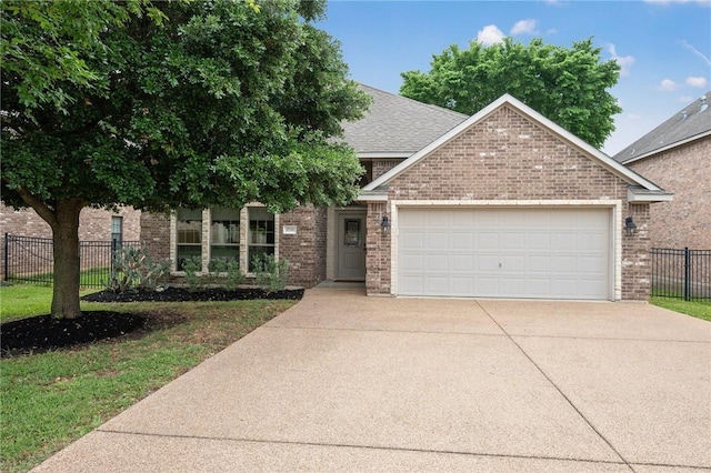 view of front of home featuring fence, concrete driveway, an attached garage, and brick siding