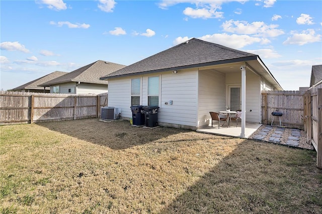 rear view of property with a patio and a lawn