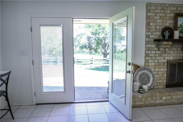 doorway with light tile patterned floors and a healthy amount of sunlight