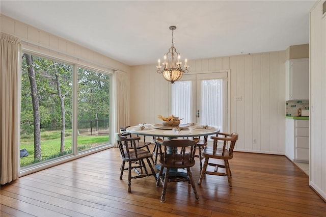 dining area with a chandelier and wood-type flooring