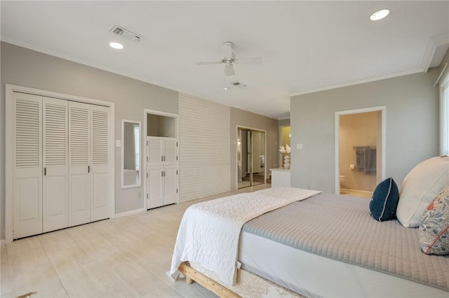 bedroom with two closets, ensuite bath, ceiling fan, and ornamental molding