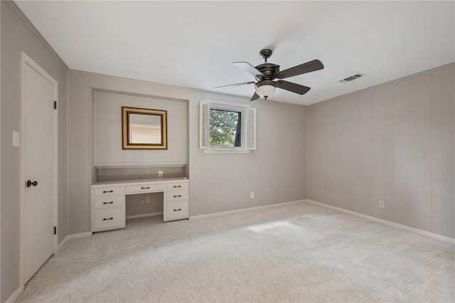 unfurnished bedroom featuring light colored carpet and ceiling fan