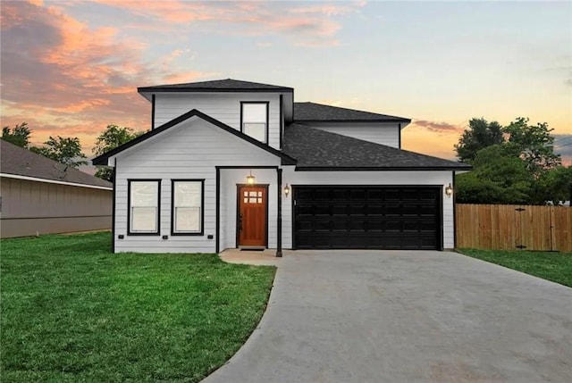 view of front of property with a lawn and a garage