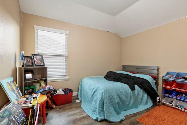 bedroom featuring lofted ceiling and wood-type flooring