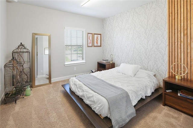 bedroom with carpet floors, wallpapered walls, and baseboards