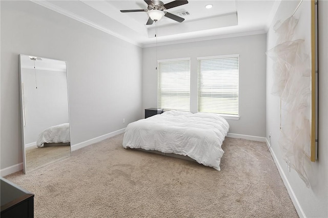 carpeted bedroom featuring a raised ceiling, visible vents, crown molding, and baseboards