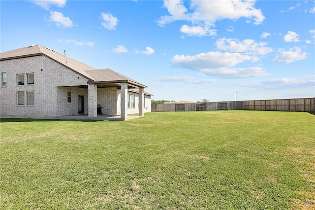 view of yard with a fenced backyard and a patio