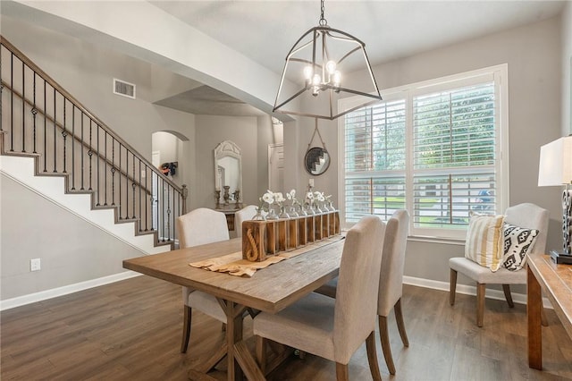 4143 Shallow Creek Loop, College Station, TX 77845 - dining room with baseboards, a chandelier, arched walkways, dark wood-type flooring, and stairway