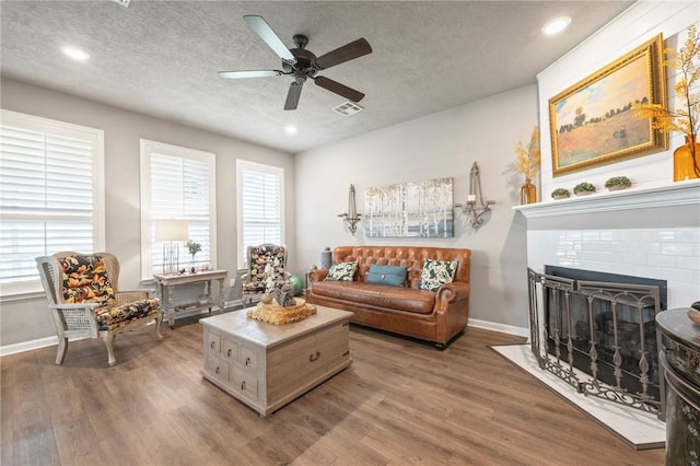 4143 Shallow Creek Loop, College Station, TX 77845 - living area with wood finished floors, plenty of natural light, a ceiling fan, a textured ceiling, and recessed lighting