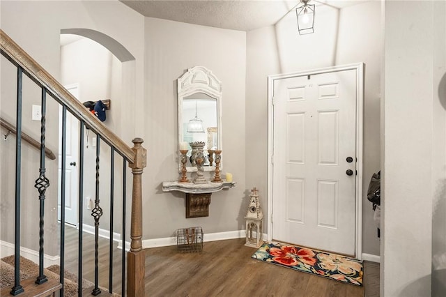 4143 Shallow Creek Loop, College Station, TX 77845 - foyer entrance featuring wood finished floors, stairway, baseboards, and arched walkways