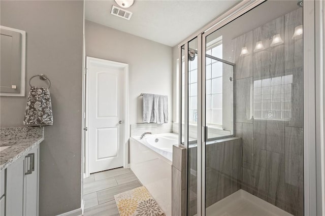 4143 Shallow Creek Loop, College Station, TX 77845 - bathroom featuring a bath, a stall shower, vanity, and baseboards