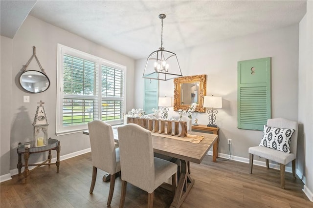 4143 Shallow Creek Loop, College Station, TX 77845 - dining room with a chandelier, wood finished floors, and baseboards