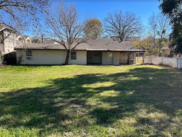 back of property featuring a lawn