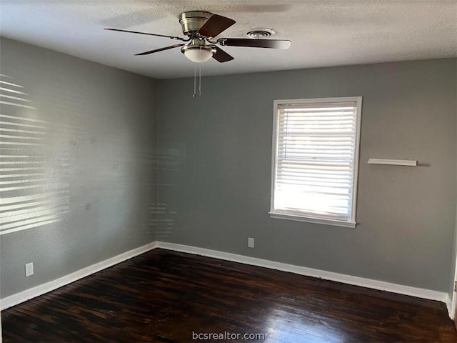 unfurnished room featuring ceiling fan, dark hardwood / wood-style flooring, and a textured ceiling