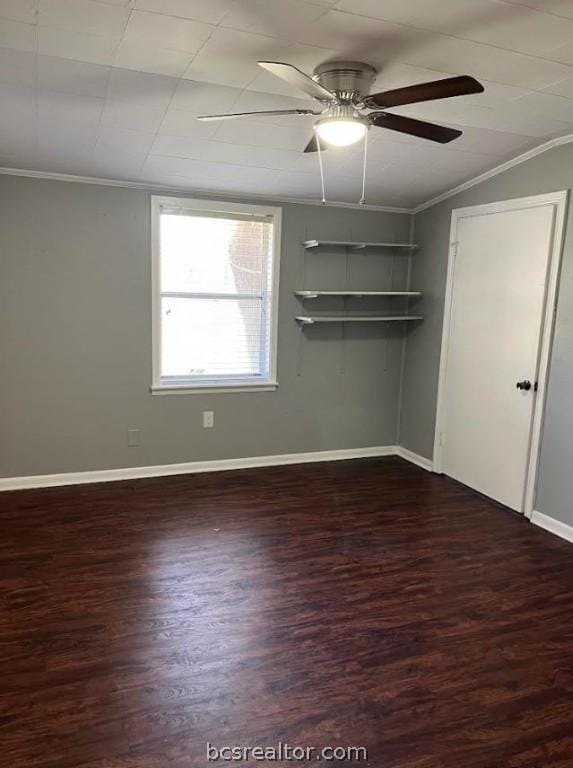 spare room with ceiling fan, dark hardwood / wood-style flooring, and ornamental molding