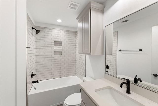 full bathroom featuring vanity, toilet, and tiled shower / bath combo