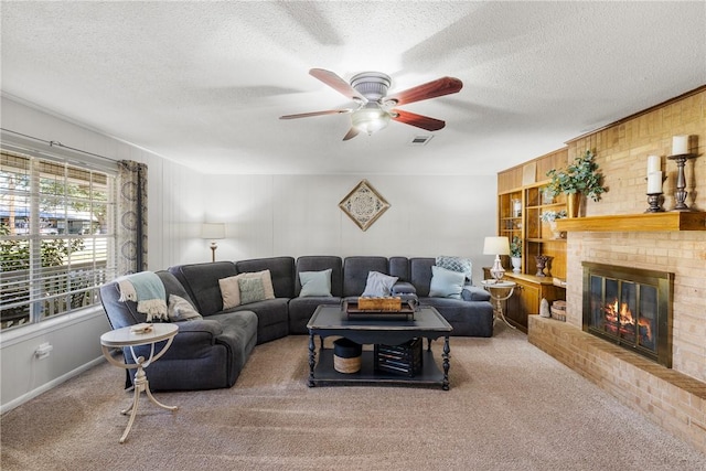 living area featuring visible vents, a textured ceiling, a brick fireplace, and carpet flooring