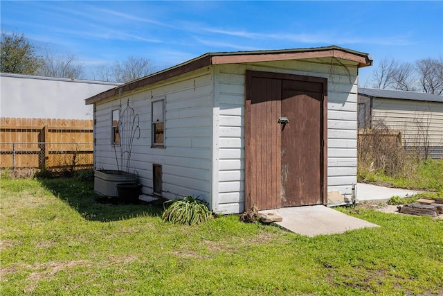 view of shed featuring fence