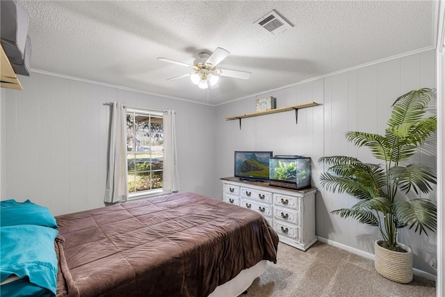 bedroom with visible vents, light carpet, a textured ceiling, and ornamental molding