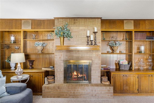 carpeted living area featuring a fireplace