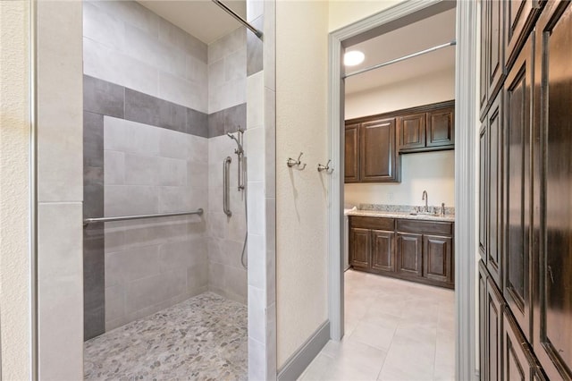 5217 Ruddy Duck Dr, College Station, TX 77845 - full bath featuring tiled shower, vanity, and tile patterned flooring