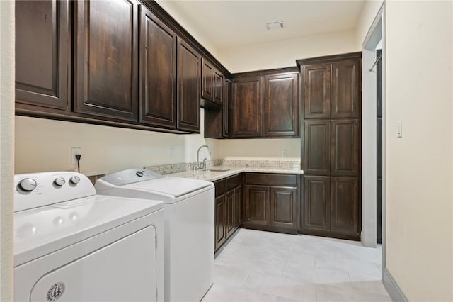 5217 Ruddy Duck Dr, College Station, TX 77845 - laundry area featuring cabinet space, washing machine and dryer, and light tile patterned floors