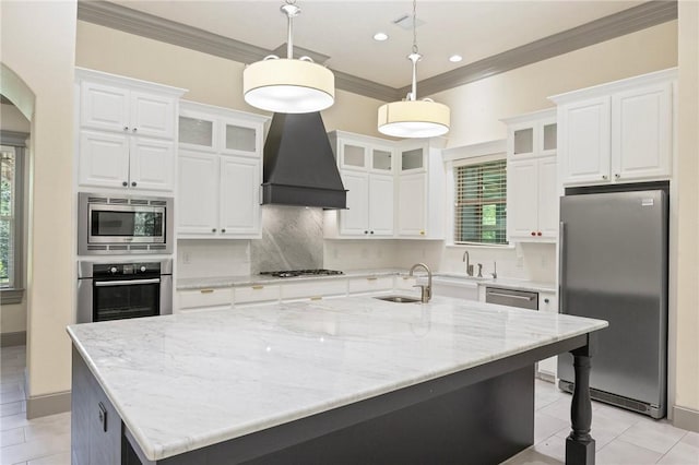5217 Ruddy Duck Dr, College Station, TX 77845 - kitchen featuring stainless steel appliances, light tile patterned flooring, crown molding, white cabinetry, and a large island