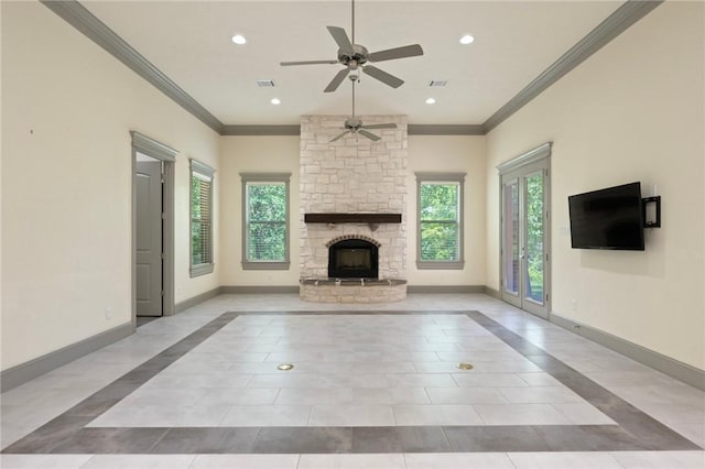 5217 Ruddy Duck Dr, College Station, TX 77845 - unfurnished living room featuring healthy amount of natural light, ceiling fan, ornamental molding, a stone fireplace, and tile patterned floors
