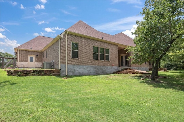 5217 Ruddy Duck Dr, College Station, TX 77845 - back of house with brick siding, a lawn, and french doors