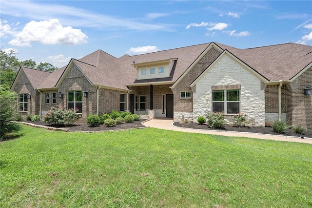 5217 Ruddy Duck Dr, College Station, TX 77845 - view of front of home featuring stone siding, a front lawn, brick siding, and a shingled roof