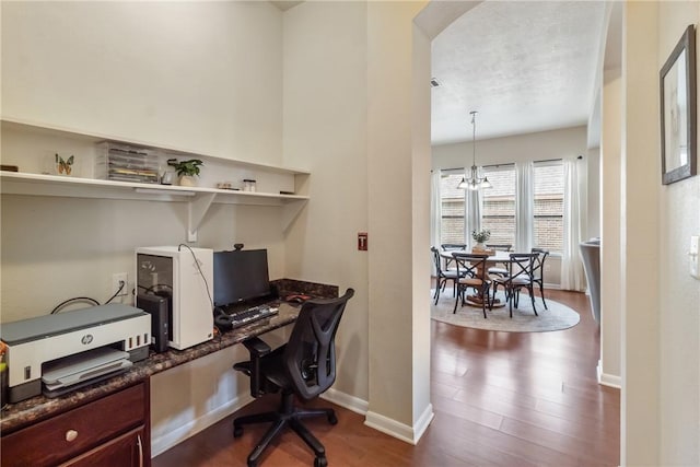 4205 Cripple Creek Ct, College Station, TX 77845 - office area featuring dark wood-style flooring, a chandelier, baseboards, and built in desk