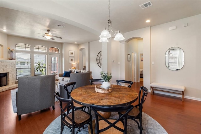 4205 Cripple Creek Ct, College Station, TX 77845 - dining space featuring arched walkways, ceiling fan, dark wood finished floors, a stone fireplace, and recessed lighting