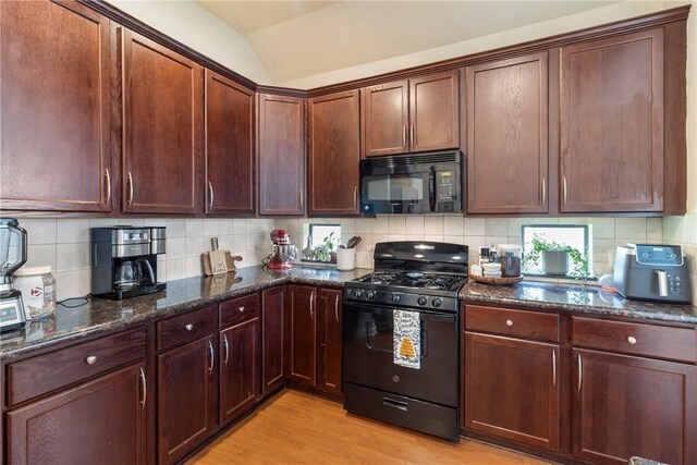 4205 Cripple Creek Ct, College Station, TX 77845 - kitchen featuring black appliances, dark stone counters, light wood-style floors, lofted ceiling, and backsplash