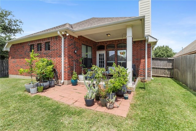 4205 Cripple Creek Ct, College Station, TX 77845 - back of house featuring a chimney, brick siding, and a patio