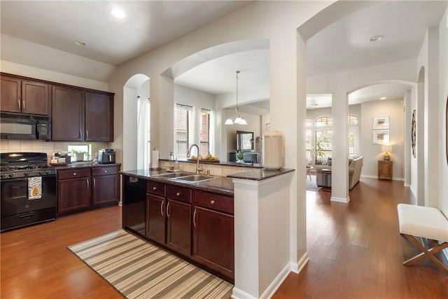 4205 Cripple Creek Ct, College Station, TX 77845 - kitchen with black appliances, a sink, wood finished floors, tasteful backsplash, and recessed lighting