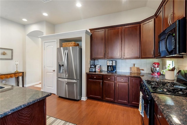 4205 Cripple Creek Ct, College Station, TX 77845 - kitchen featuring black appliances, light wood-type flooring, tasteful backsplash, recessed lighting, and dark stone counters