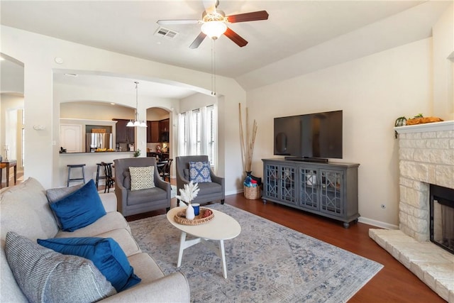 4205 Cripple Creek Ct, College Station, TX 77845 - living area featuring arched walkways, ceiling fan, wood finished floors, a fireplace, and baseboards