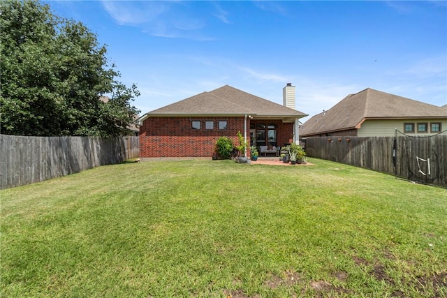 4205 Cripple Creek Ct, College Station, TX 77845 - back of house with brick siding, a patio area, and a chimney