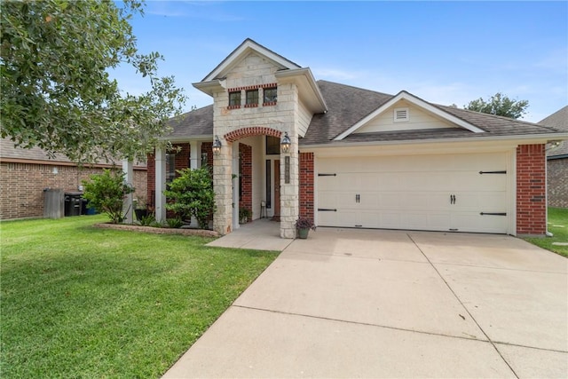 4205 Cripple Creek Ct, College Station, TX 77845 - view of front of house featuring stone siding, a shingled roof, brick siding, an attached garage, and a front lawn