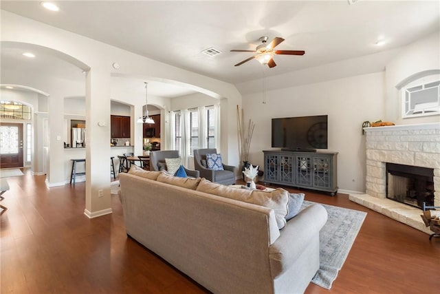 4205 Cripple Creek Ct, College Station, TX 77845 - living area with arched walkways, a ceiling fan, recessed lighting, dark wood-style flooring, and baseboards