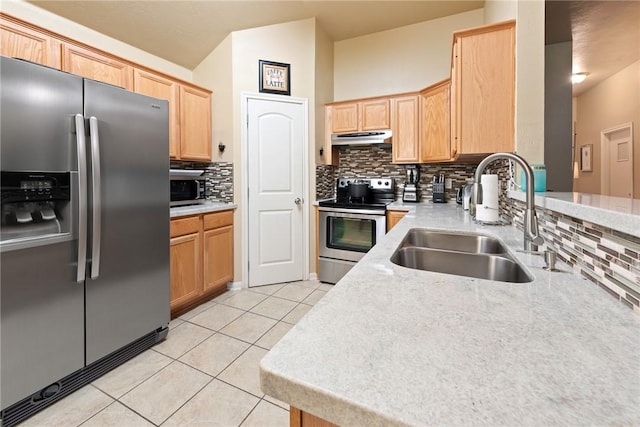 kitchen featuring appliances with stainless steel finishes, light brown cabinetry, sink, backsplash, and light tile patterned floors