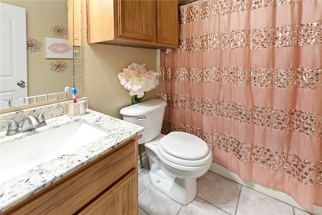 bathroom with vanity, tile patterned flooring, and toilet