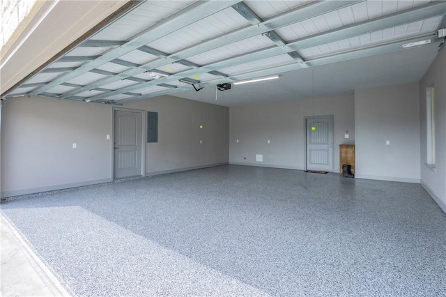 garage featuring electric panel and a garage door opener