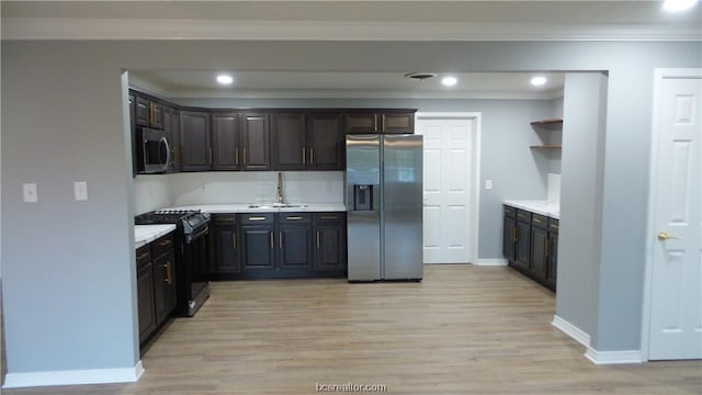 kitchen with crown molding, sink, stainless steel appliances, and light wood-type flooring