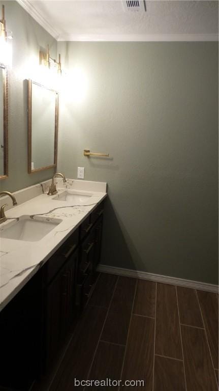 bathroom with hardwood / wood-style flooring, vanity, and ornamental molding